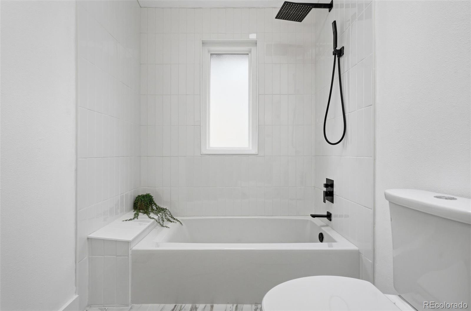 15743 Wedge Way Morrison, CO 80465 - Photo 22 of 48 a bathroom with a granite countertop bathtub shower and a toilet