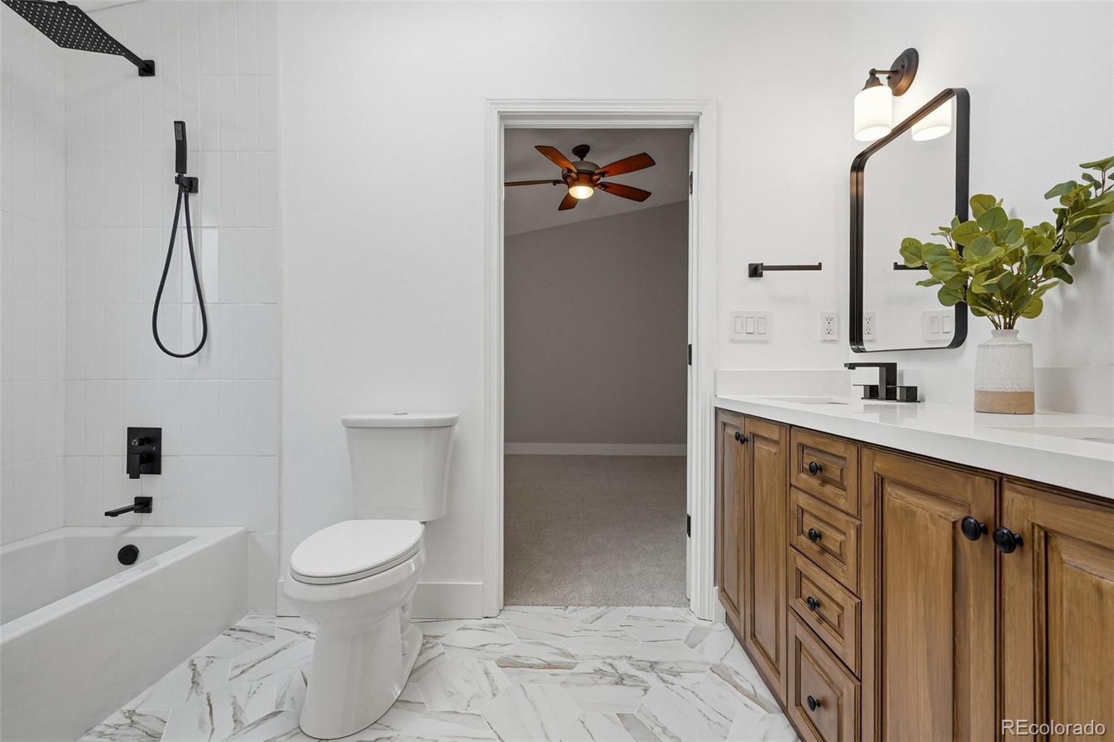 15743 Wedge Way Morrison, CO 80465 - Photo 23 of 48 a bathroom with a sink a toilet and shower