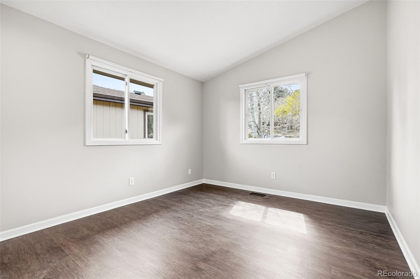15743 Wedge Way Morrison, CO 80465 - Photo 24 of 48 a view of an empty room with wooden floor and a window
