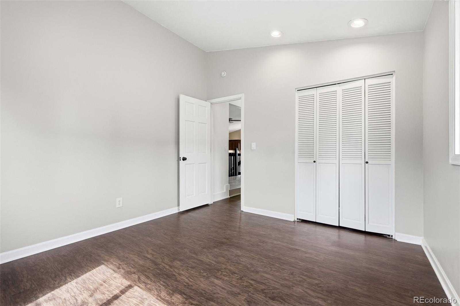 15743 Wedge Way Morrison, CO 80465 - Photo 25 of 48 an empty room with wooden floor