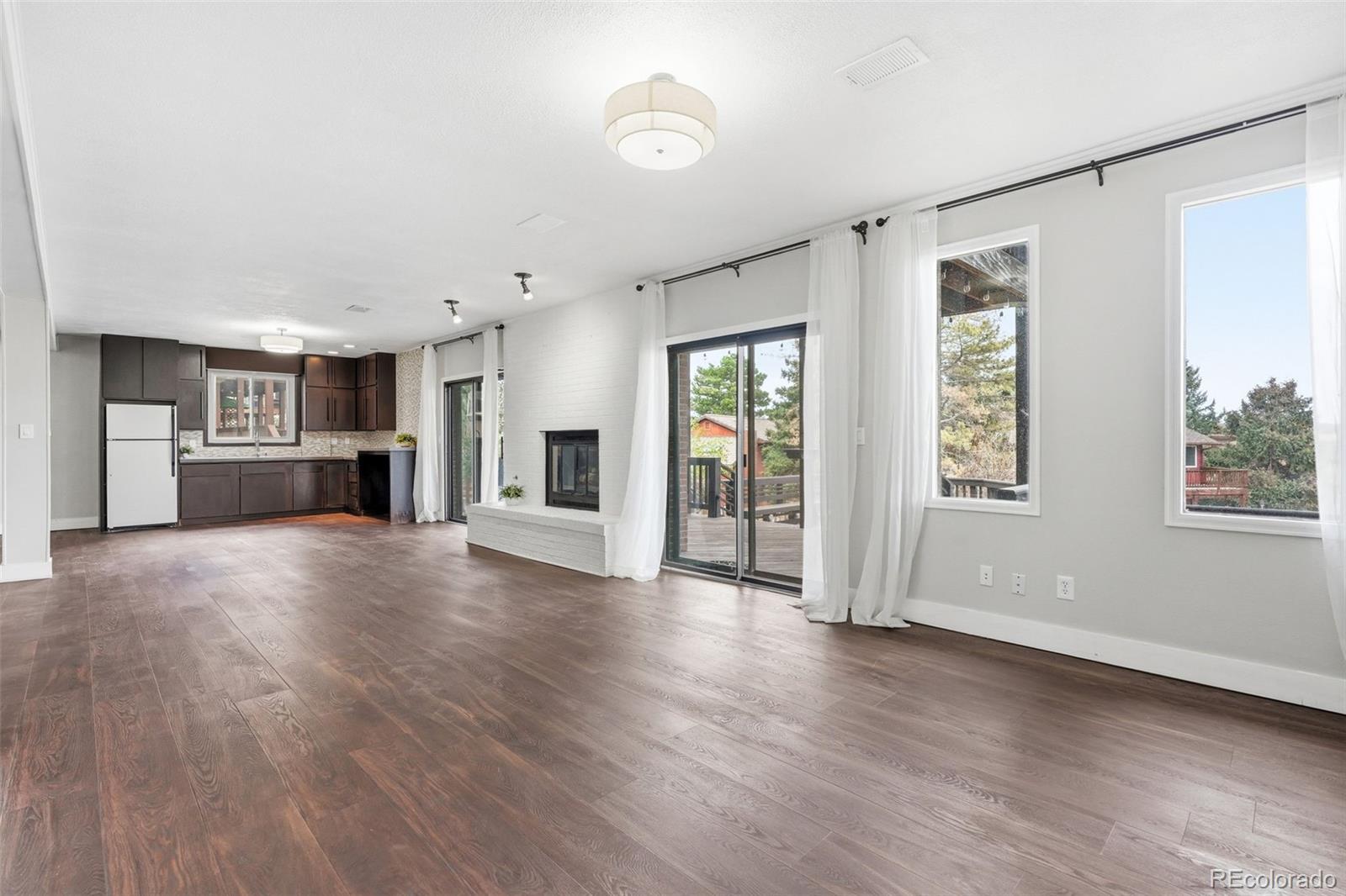 15743 Wedge Way Morrison, CO 80465 - Photo 30 of 48 a view of empty room with wooden floor and windows