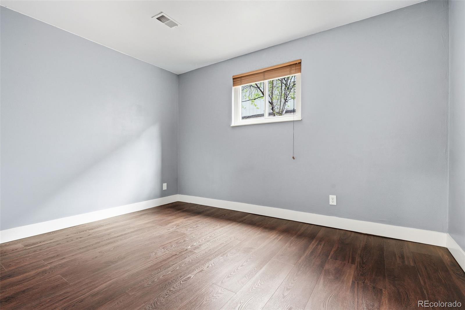 15743 Wedge Way Morrison, CO 80465 - Photo 34 of 48 a view of an empty room with wooden floor and a window