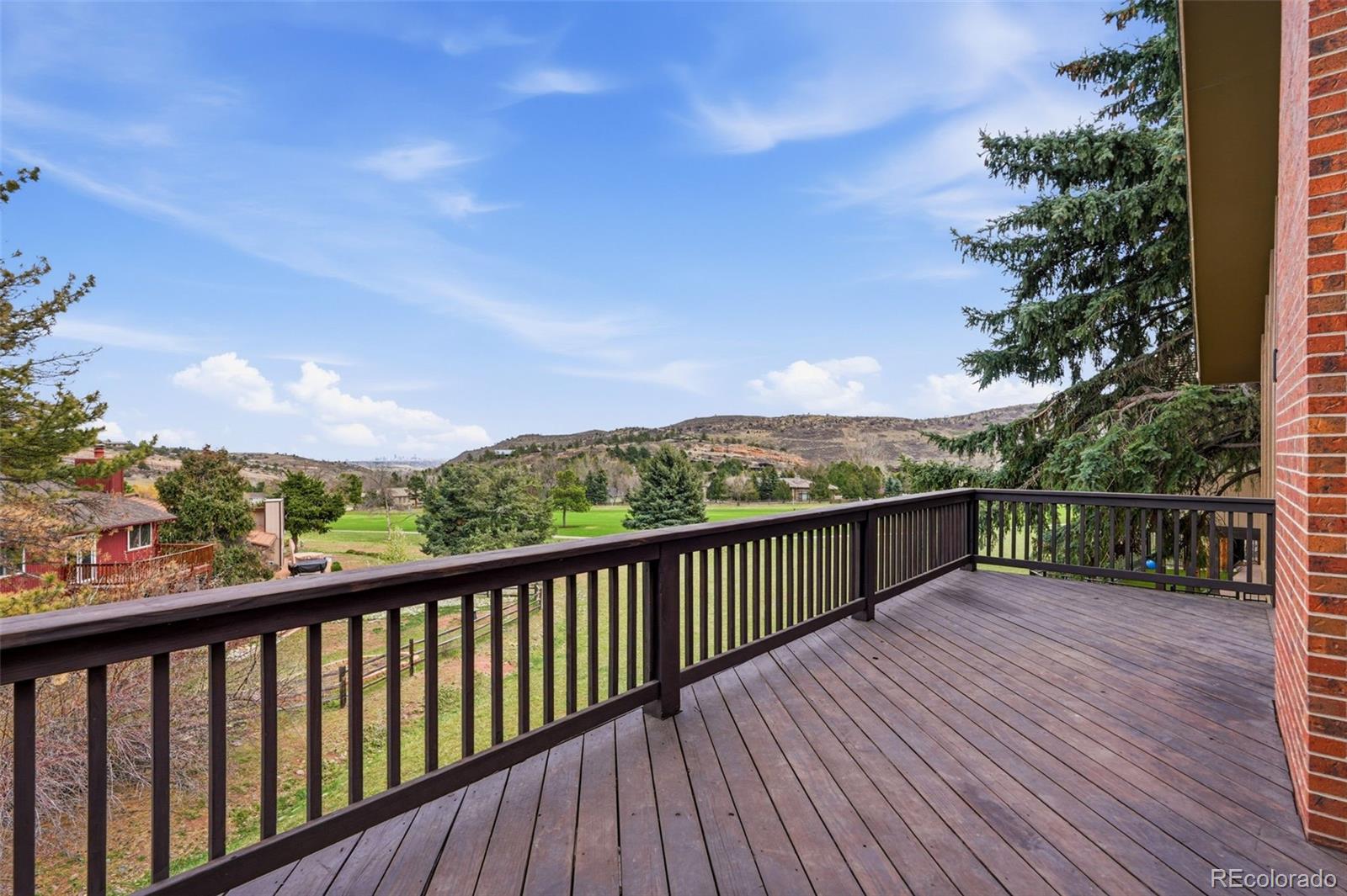 15743 Wedge Way Morrison, CO 80465 - Photo 38 of 48 a view of a balcony with wooden floor and fence