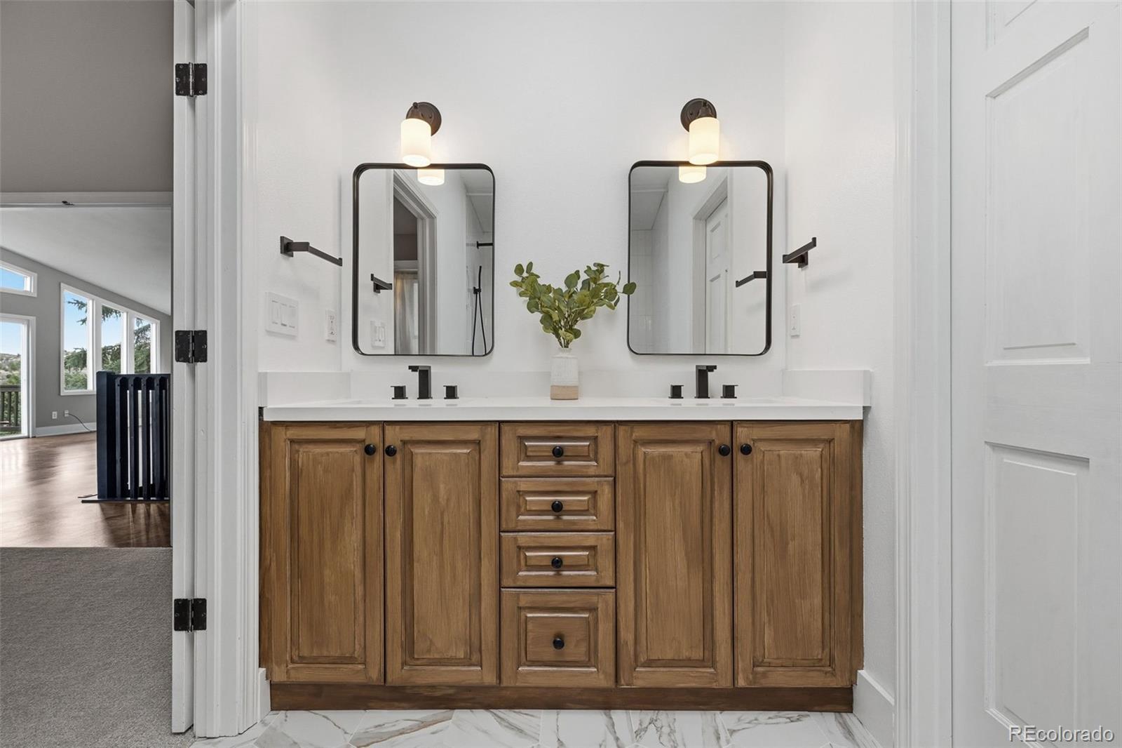 15743 Wedge Way Morrison, CO 80465 - Photo 8 of 48 a bathroom with double vanity sinks and a mirror