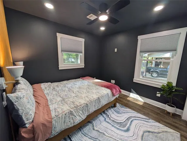 a bedroom with a bed and a painting on the wall