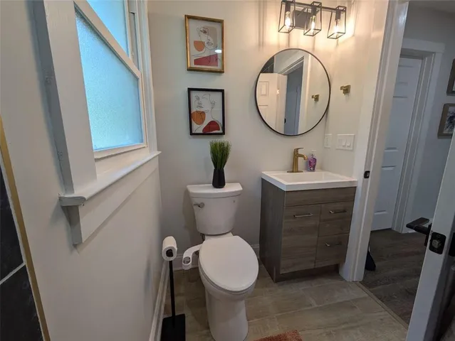 a bathroom with a toilet a sink and a mirror