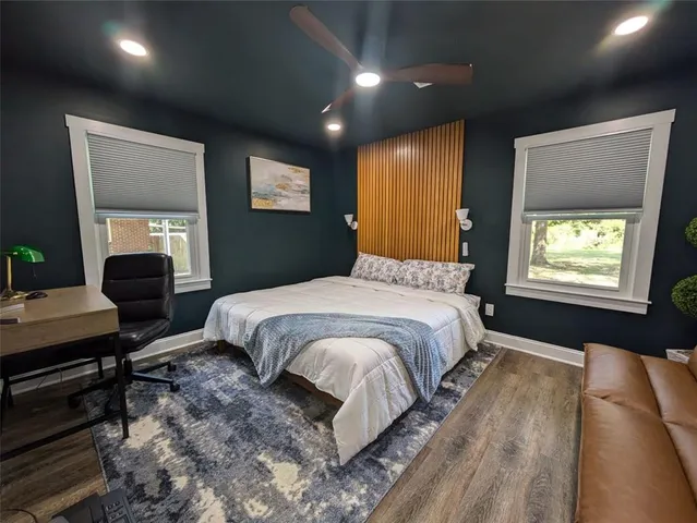 a spacious bedroom with a bed and a dresser in it