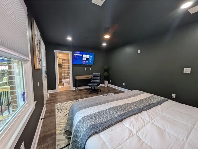 a bedroom with a bed and a flat screen tv