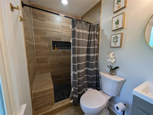 a bathroom with a toilet and a shower