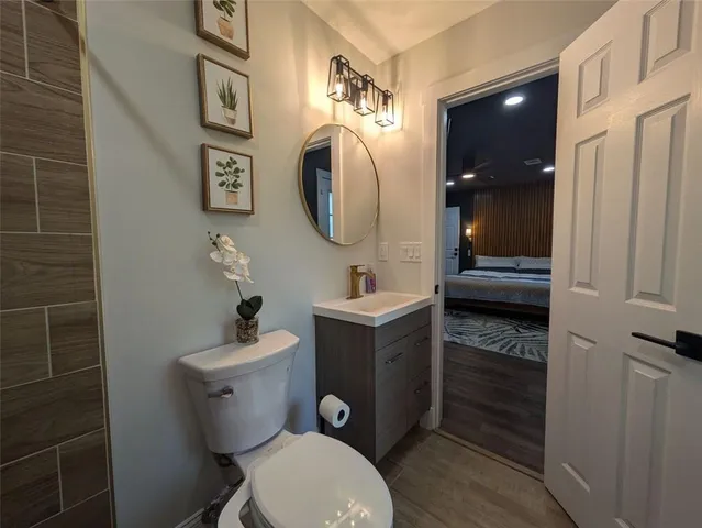 a bathroom with a toilet sink and mirror
