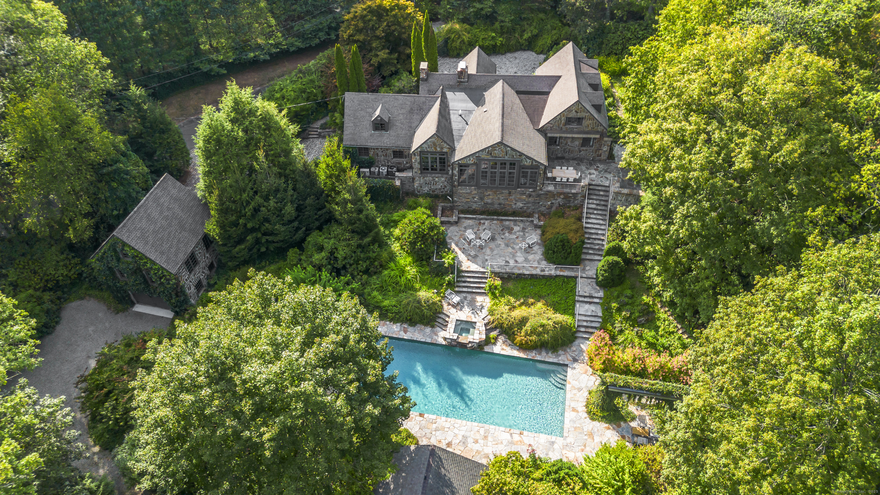 an aerial view of a house with a yard and garden