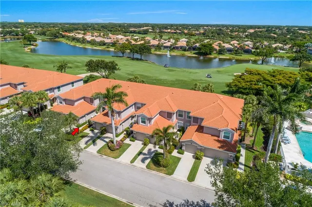 an aerial view of a house with a garden and lake view