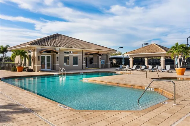 a view of a house with swimming pool and sitting area