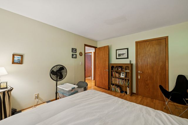 a living room with furniture a bookshelf and a flat screen tv