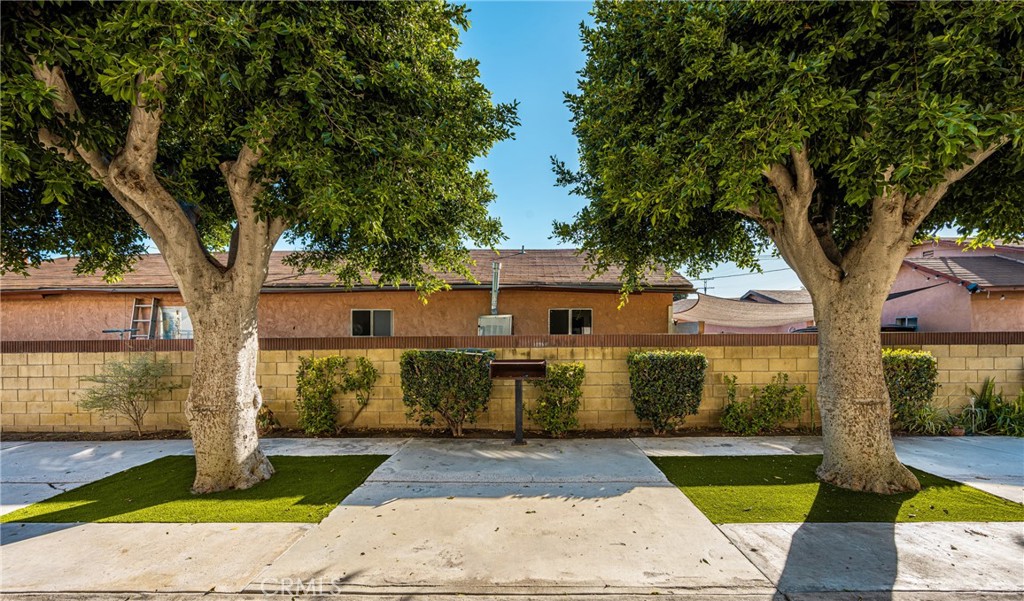 6725 Perry Road Bell Gardens, CA 90201 - Photo 6 of 40 a view of a yard with plants and large trees