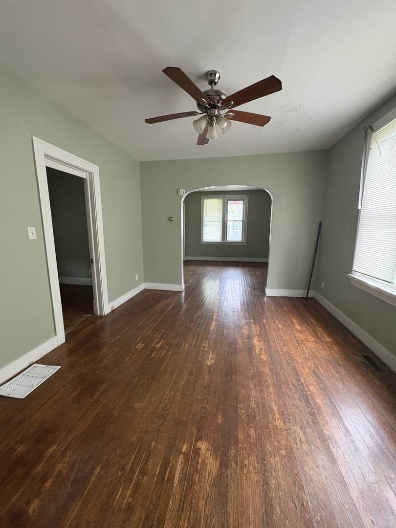 72 19th Street Chicago Heights, IL 60411 - Photo 3 of 7 a view of empty room with wooden floor and fan