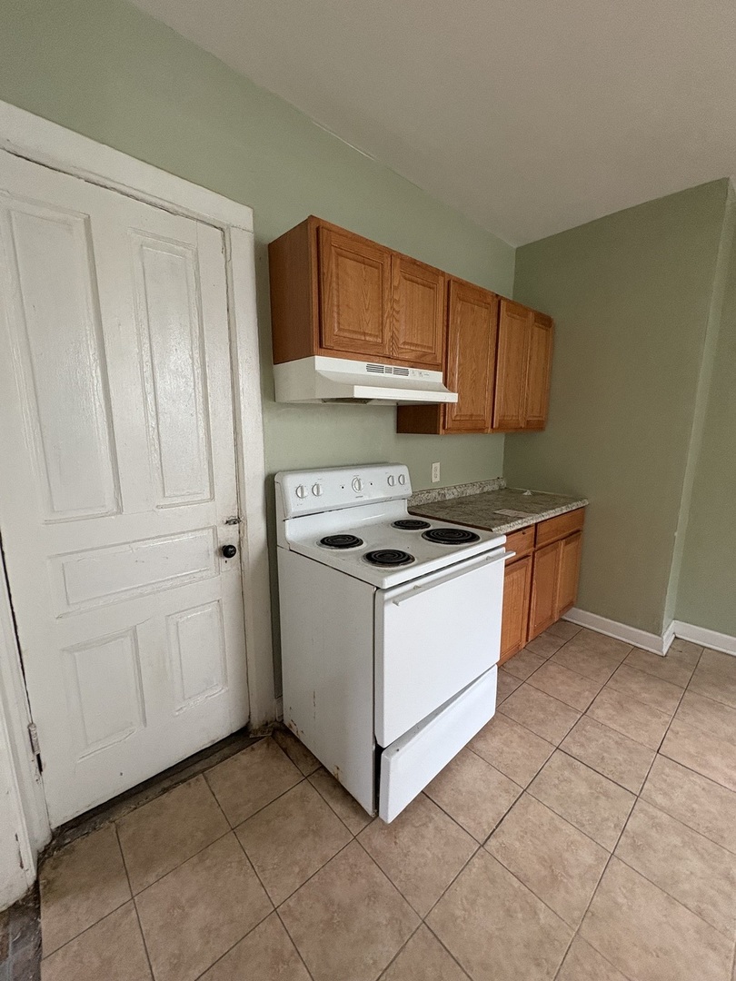 72 19th Street Chicago Heights, IL 60411 - Photo 4 of 7 a kitchen with cabinets and white appliances