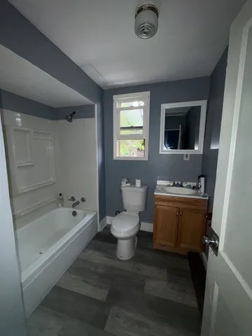 a bathroom with a toilet a sink and bathtub