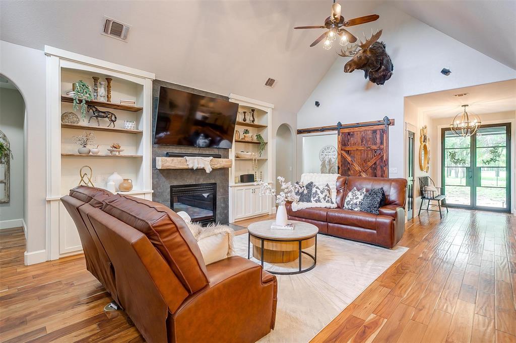 4962 Farm To Market 113 Millsap, TX 76066 - Photo 12 of 36 a living room with furniture a flat screen tv and a fireplace
