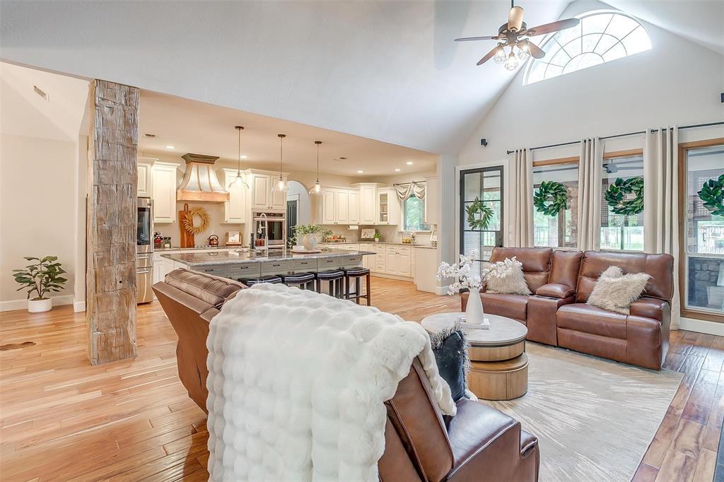 4962 Farm To Market 113 Millsap, TX 76066 - Photo 13 of 36 a living room with furniture a rug and a chandelier