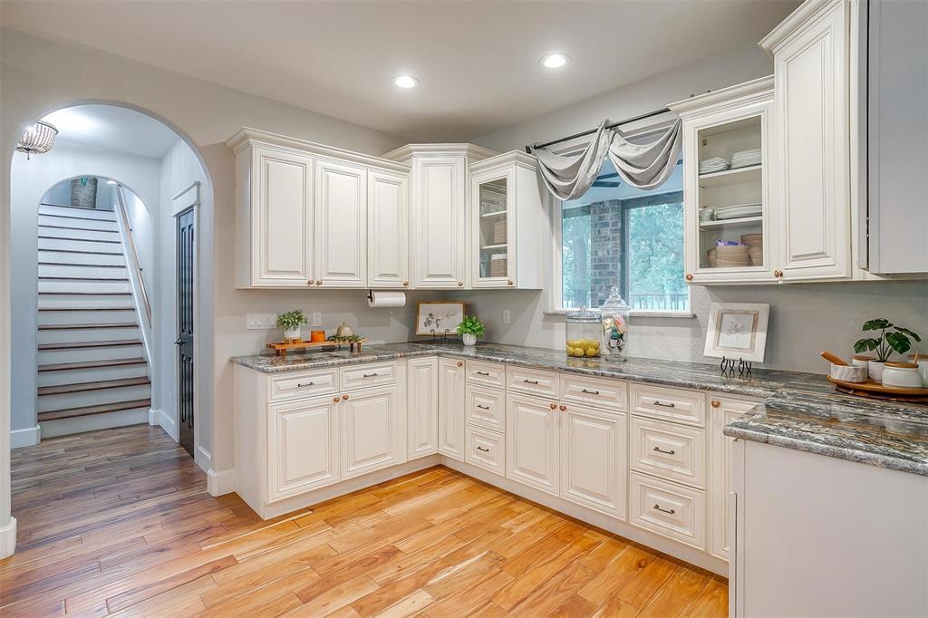 4962 Farm To Market 113 Millsap, TX 76066 - Photo 15 of 36 a kitchen with granite countertop white cabinets and white appliances