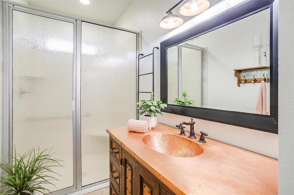 4962 Farm To Market 113 Millsap, TX 76066 - Photo 35 of 36 a bathroom with a granite countertop sink a mirror and a shower