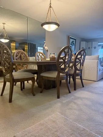 a view of a dining room with furniture and chandelier
