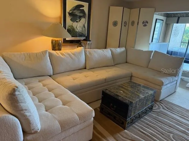 a living room with a couch and a rug