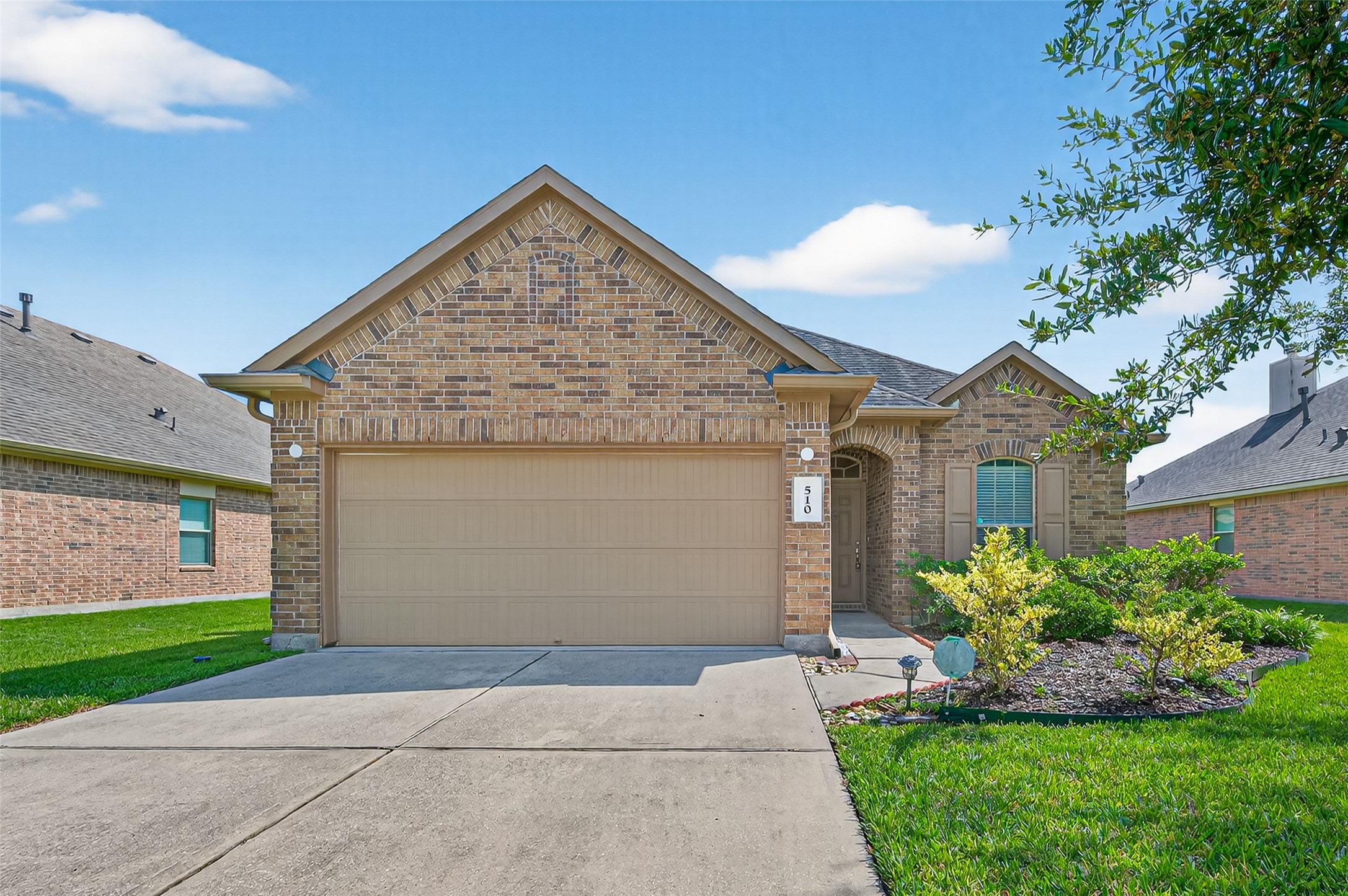 a view of a house with a yard and plants