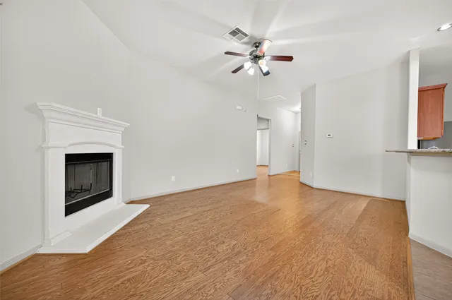 a view of an empty room with a fireplace