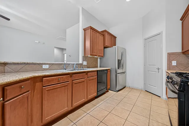 a kitchen with stainless steel appliances a refrigerator sink and cabinets