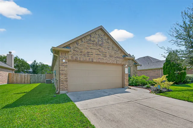 a front view of house with backyard and green space