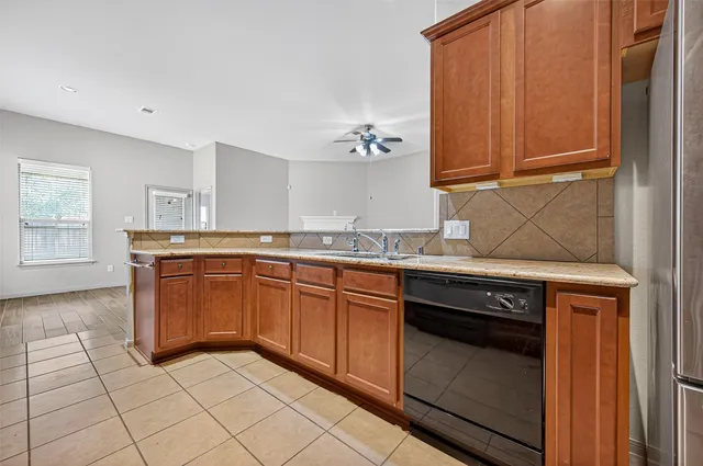 a kitchen with granite countertop a sink and cabinets
