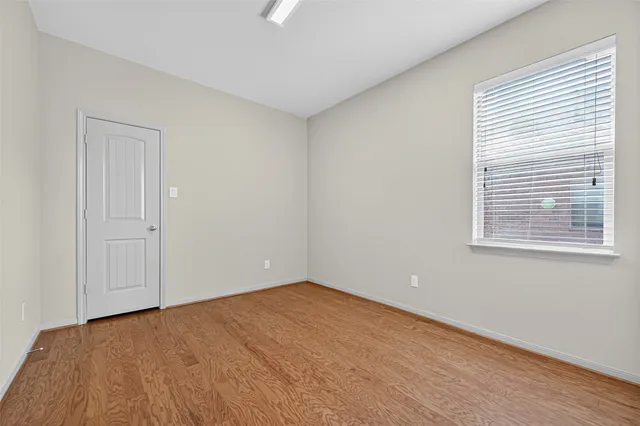 wooden floor in an empty room with a window