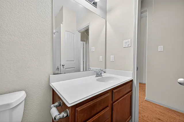 a bathroom with a sink a toilet and a mirror
