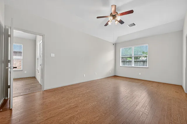wooden floor in an empty room with a window