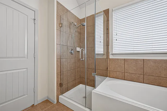 a bathroom with a bathtub and a shower