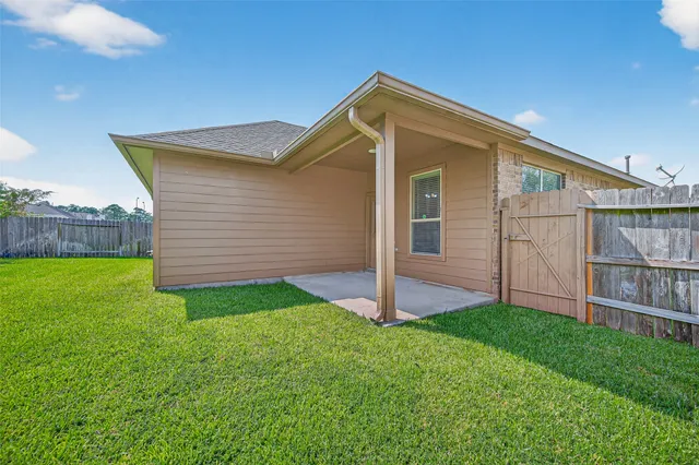 a front view of house with backyard and green space