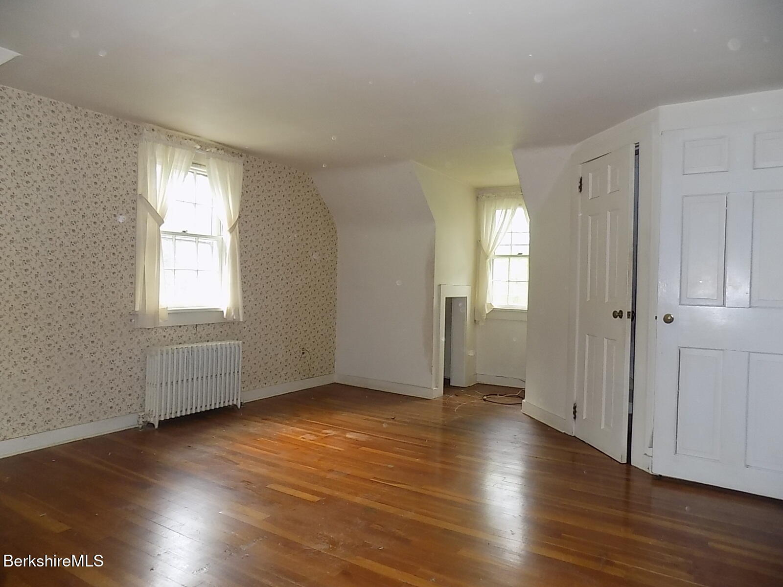 350 Laurel Street Lee, MA 01238 - Photo 14 of 34 an empty room with wooden floor and windows