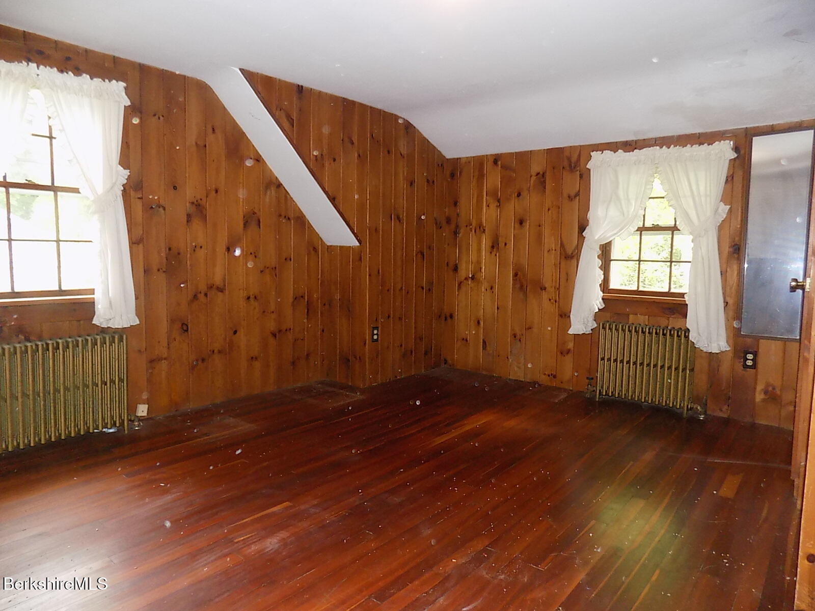 350 Laurel Street Lee, MA 01238 - Photo 19 of 34 a view of an empty room with wooden floor and a window