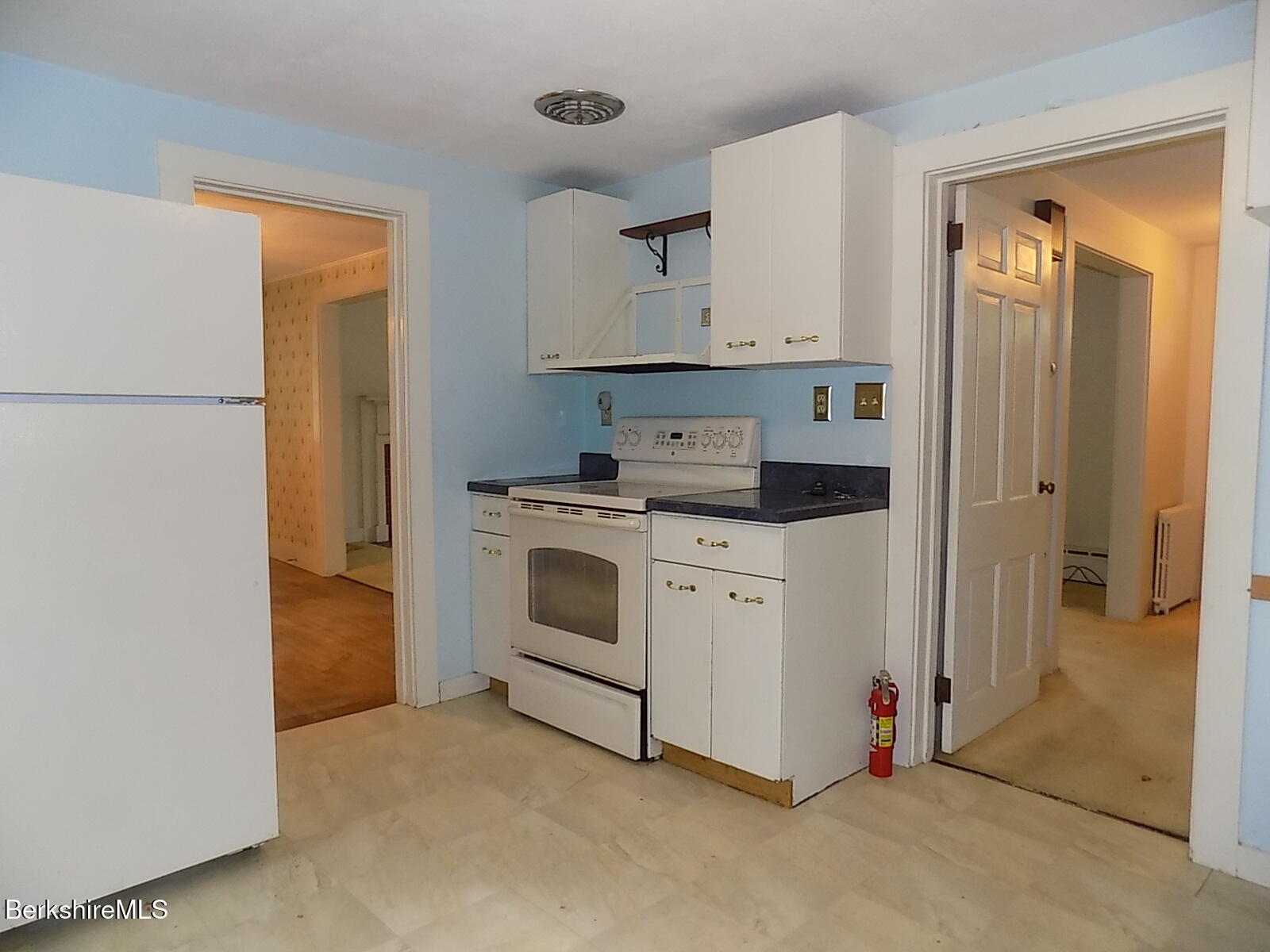 350 Laurel Street Lee, MA 01238 - Photo 10 of 34 a kitchen with white cabinets and white appliances