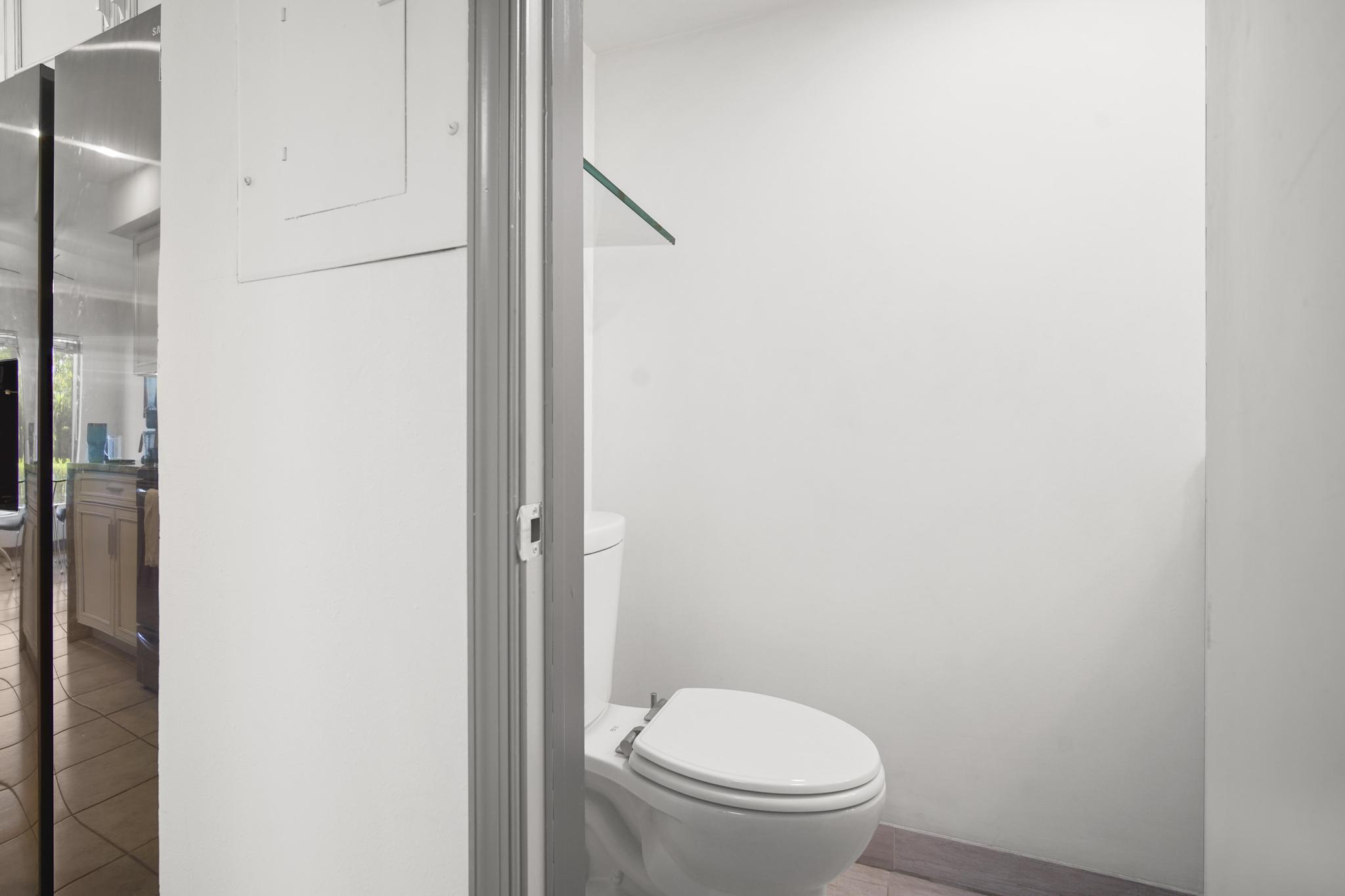 149 Northwest 70th Street, Unit 214C Boca Raton, FL 33487 - Photo 13 of 35 a white toilet sitting next to a shower
