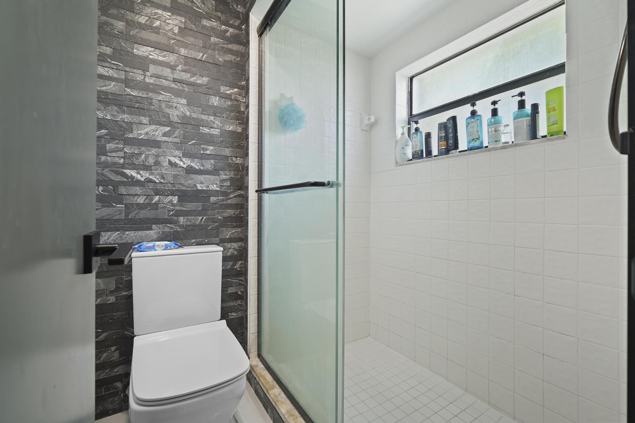 149 Northwest 70th Street, Unit 214C Boca Raton, FL 33487 - Photo 23 of 35 a white toilet sitting next to a shower