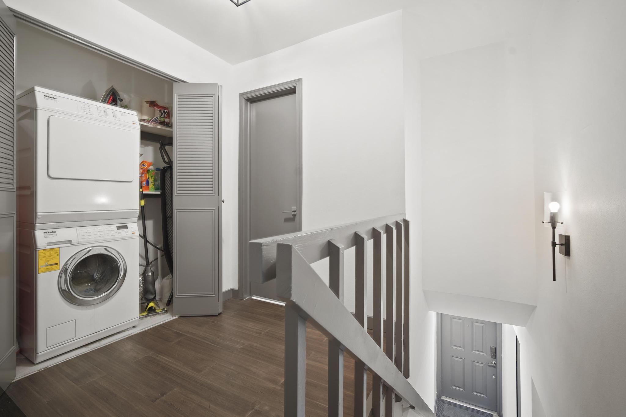 149 Northwest 70th Street, Unit 214C Boca Raton, FL 33487 - Photo 28 of 35 a view of a hallway with washer and dryer