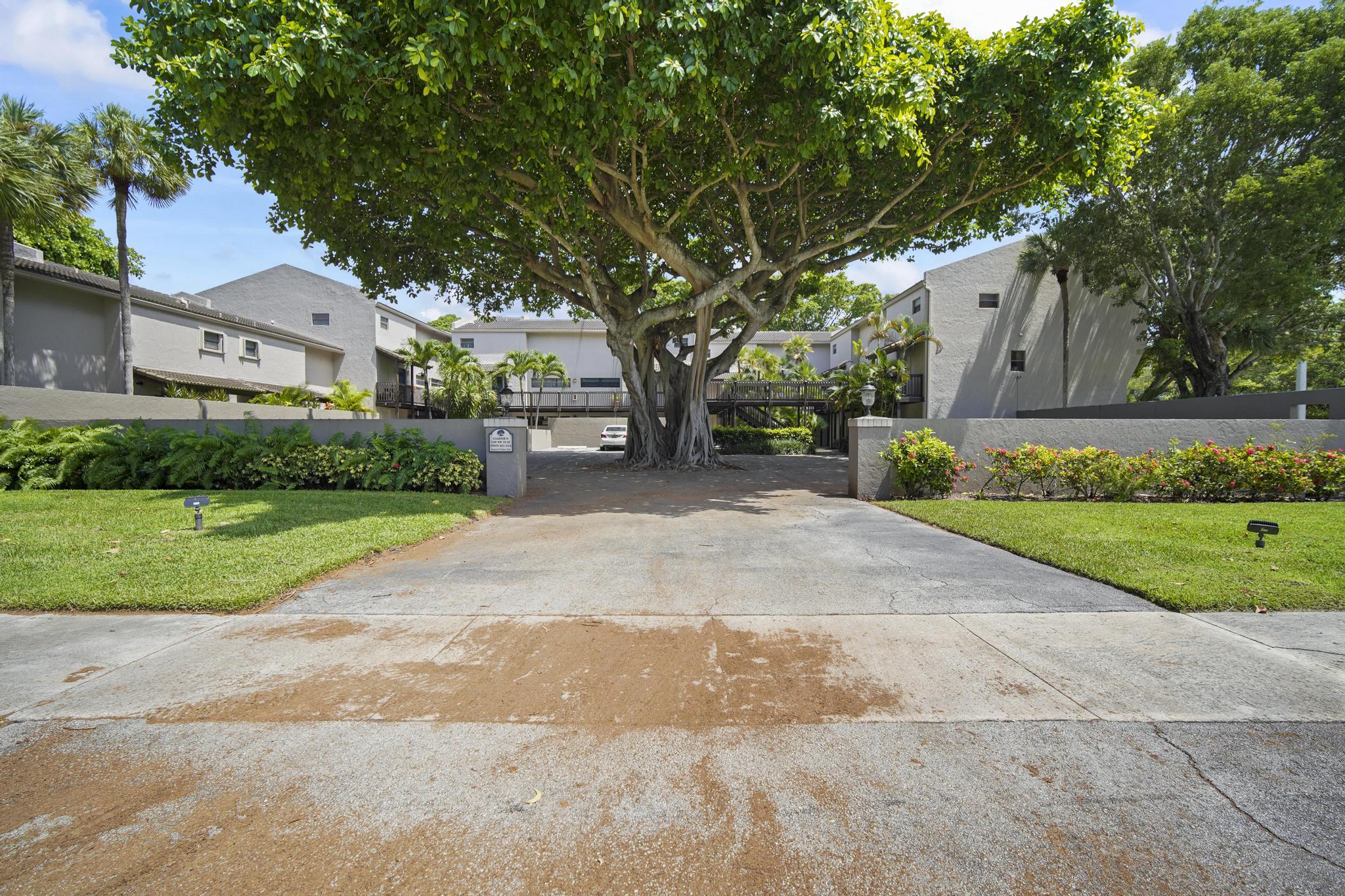 149 Northwest 70th Street, Unit 214C Boca Raton, FL 33487 - Photo 31 of 35 a view of a house with a tree in the background