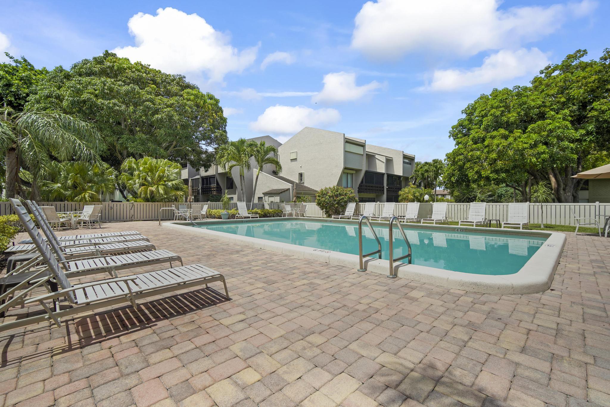 149 Northwest 70th Street, Unit 214C Boca Raton, FL 33487 - Photo 34 of 35 a view of a backyard with a garden