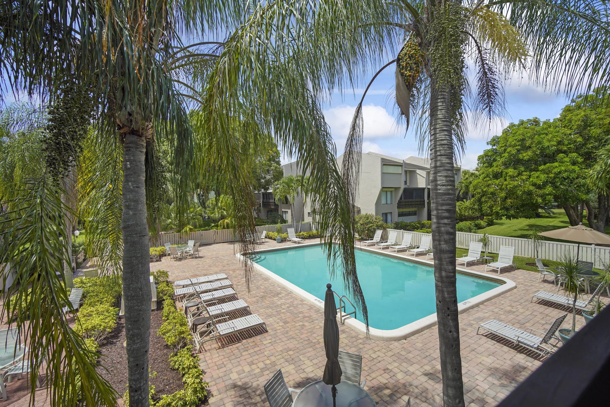 149 Northwest 70th Street, Unit 214C Boca Raton, FL 33487 - Photo 35 of 35 a view of a backyard with swimming pool