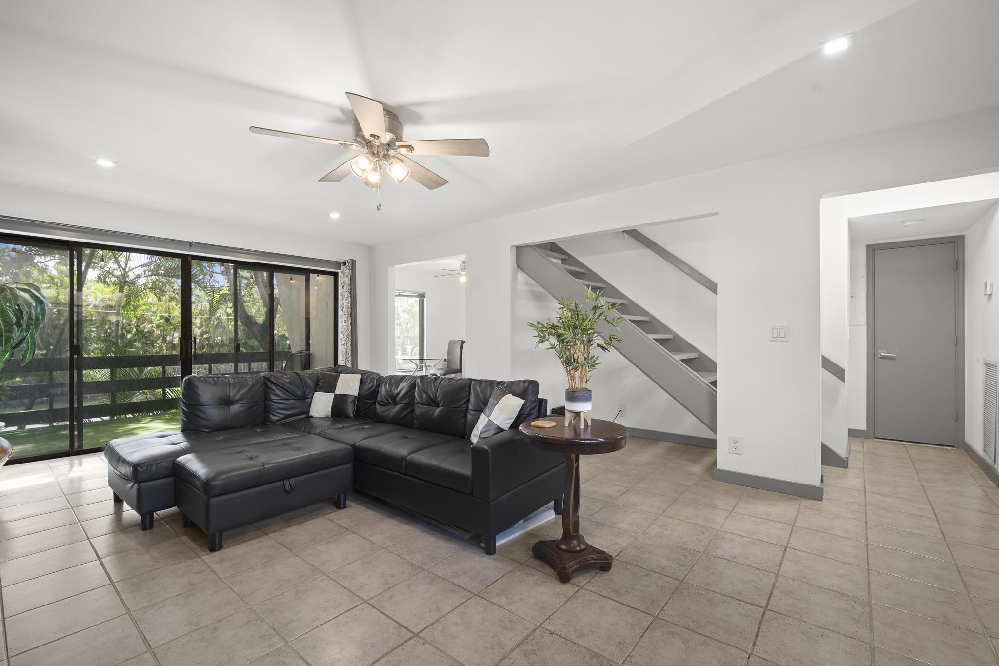 149 Northwest 70th Street, Unit 214C Boca Raton, FL 33487 - Photo 4 of 35 a living room with furniture and a large window