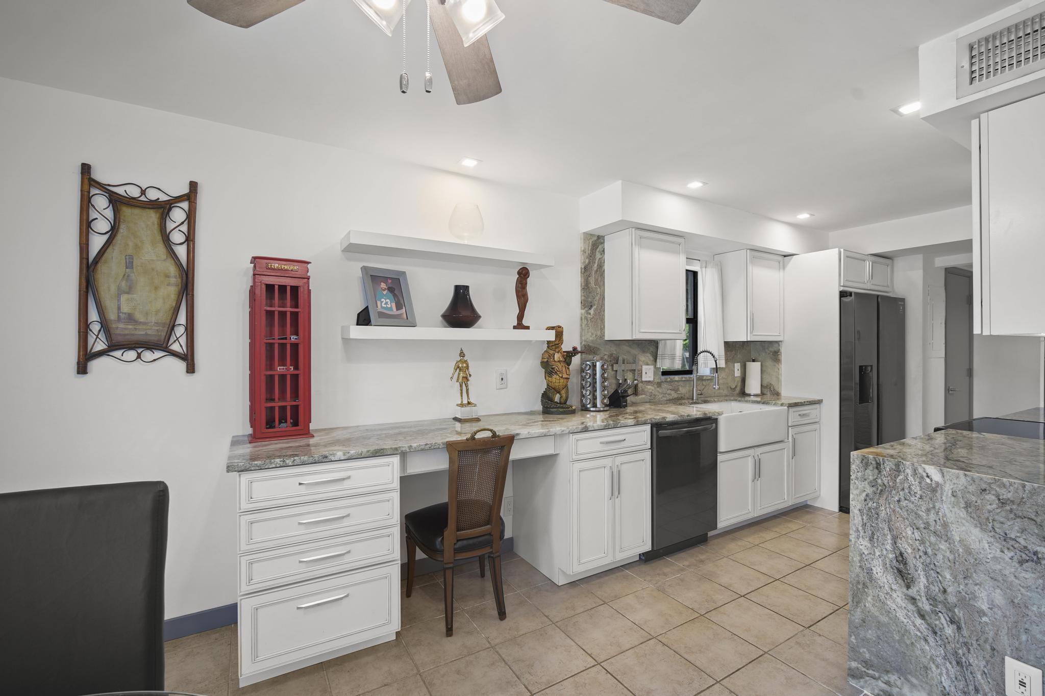 149 Northwest 70th Street, Unit 214C Boca Raton, FL 33487 - Photo 9 of 35 a kitchen with a sink and cabinets
