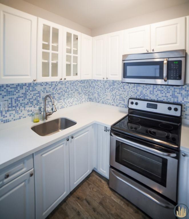 53 Northeast 49th Street, Unit 7 Miami, FL 33137 - Photo 4 of 5 a kitchen with a sink and stove top oven